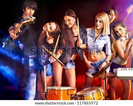 Musical group performance in night club. Lighting effects.