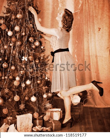 Woman dressing Christmas tree. Black and white.