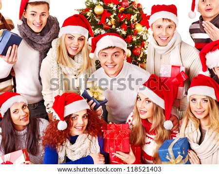 Group people  holding gift box near  Christmas tree.