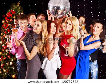 Group people with  champagne dancing at Christmas party.