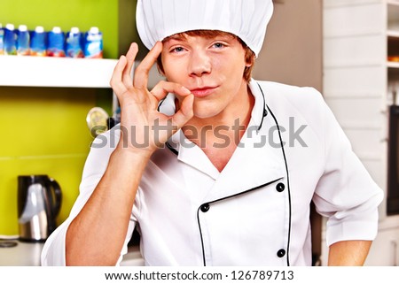 Male chef wearing uniform at cafeteria.