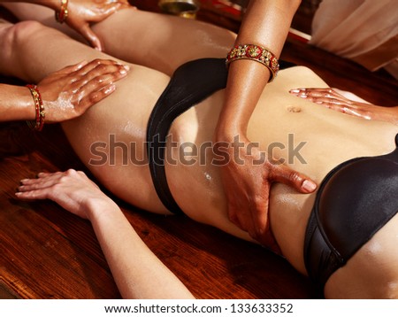 Young woman having stomach Ayurveda spa treatment.