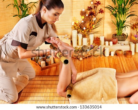 Woman getting feet massage. Male therapist.