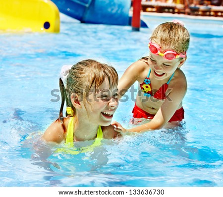 Children on water slide at aquapark Summer holiday Children on water slide at aquapark Summer holiday