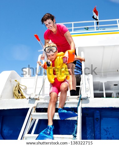 Happy family with child on yacht. Snorkeling travel.