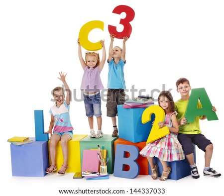 Children sitting at cube hand up Children sitting at cube hand up