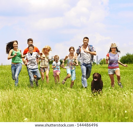 Happy group people summer outdoor with dog.