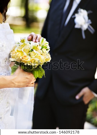 Body part bride and groom holding flower summer  outdoor.