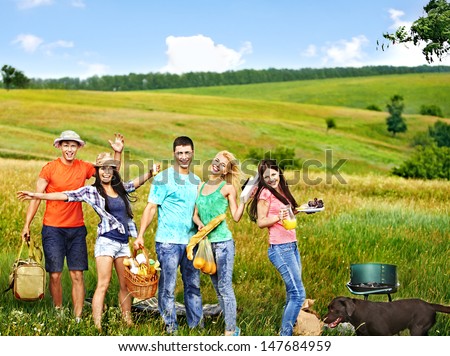 Group people with dog on picnic. Outdoor.