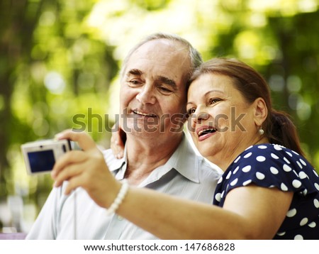Happy Old Couple With Camera Take Pictures.