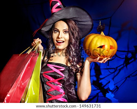 Happy woman holding Halloween shopping bag.