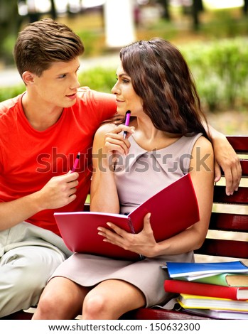 Couple student with notebook summer outdoor.