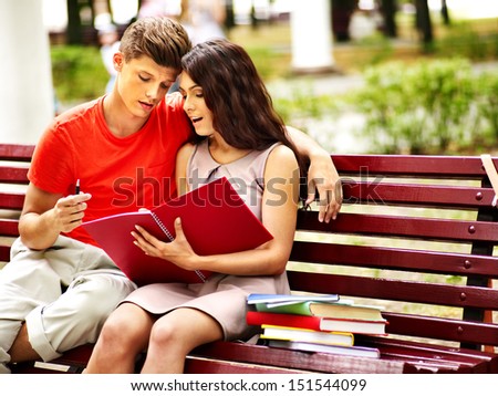 Couple student with notebook summer outdoor.
