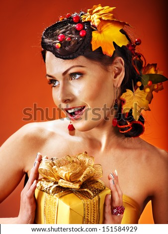 Woman with  autumn hairstyle  holding gift box.