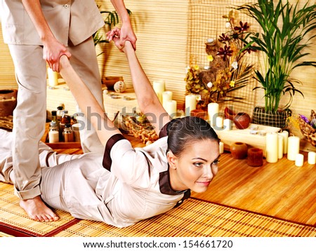 Man getting bamboo massage. Female therapist.