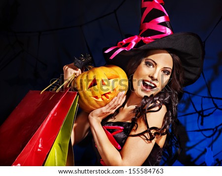 Happy woman holding Halloween shopping bag..