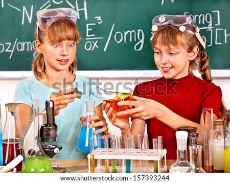 Happy child holding flask in chemistry class.