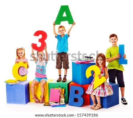 Children sitting at cube hand up Children sitting at cube hand up