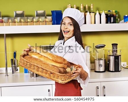 Female chef baking baguette bread