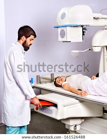 Man doctor checking patient  with trauma in x-ray room.