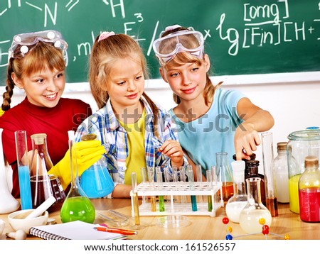 Happy Child Holding Flask In Chemistry Class.