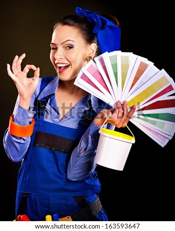 Builder woman with roll wallpaper. Fashion,