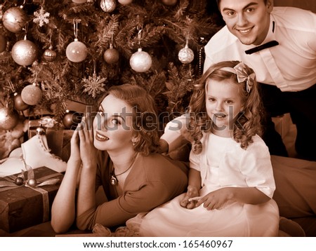 Family with children  dressing Christmas tree. Black and white retro.