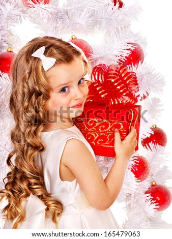 Child with gift box near white Christmas tree. Isolated.