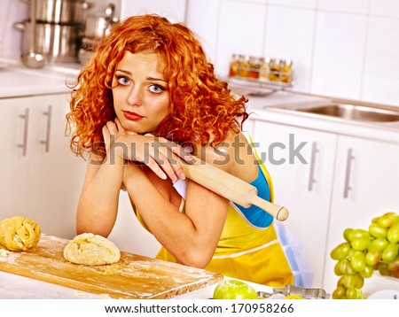 Young woman  baking cookies in oven. Bad luck.