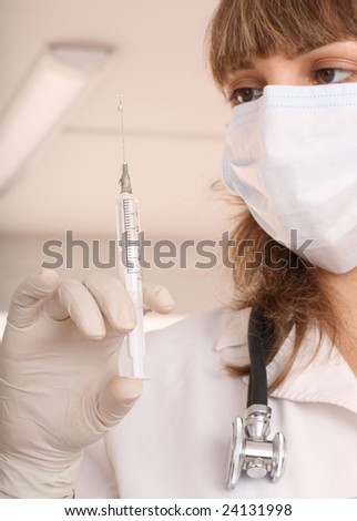 Portrait doctor with  syringe and  stethoscope. Vaccination.