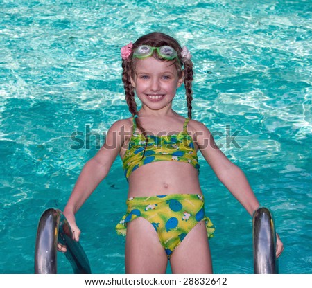Girl in protective goggles leaves pool.