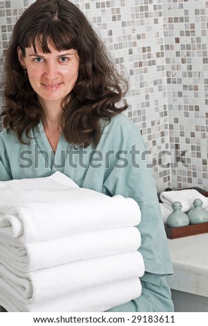 Woman with towel in spa salon. Interior.
