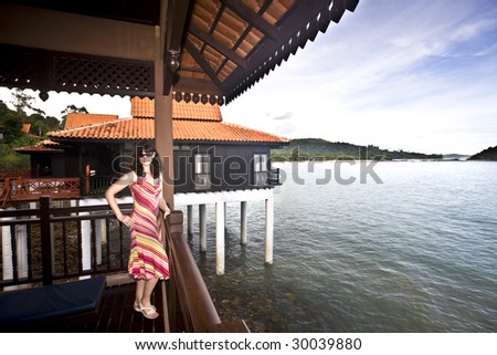 Beautiful woman in water house. Ecotourism.