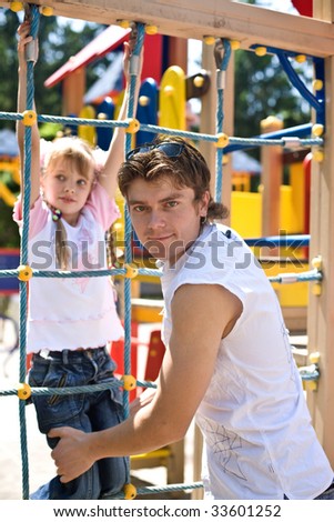 Daddy with  daughter in park on  playground. Happy family.