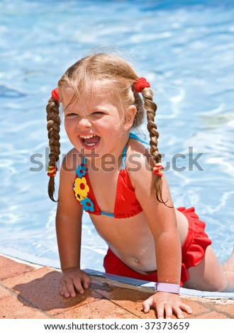 stock photo Child girl in red bikini near blue swimming pool Summer