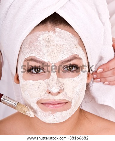 Cosmetician make  mask to  girl. Facial massage.
