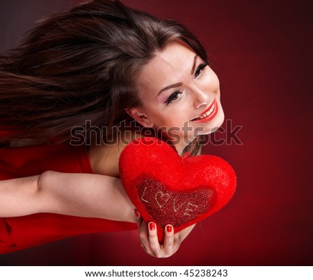Girl with heart on red background flying. Valentines day.