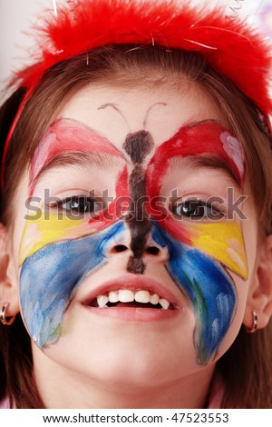 Child with paint of face. Make up.