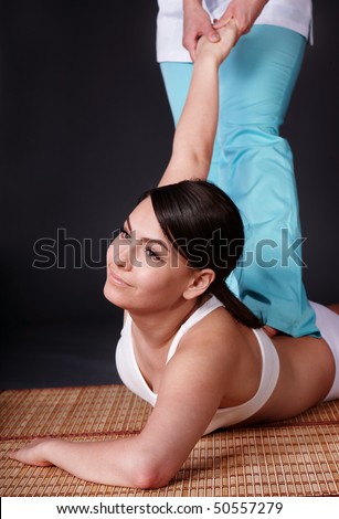 Beautiful white girl having thai massage. Beauty spa.