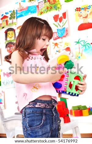 Child play block in play room. Preschool.
