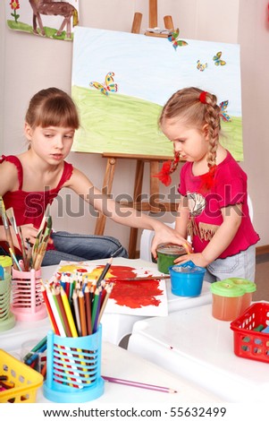 Children drawing colour pencil in play room.