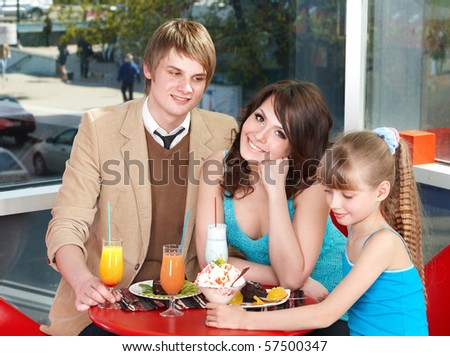 Happy family with child in cafe. Childhood.
