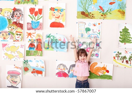 Child in art class with picture. Preschool.