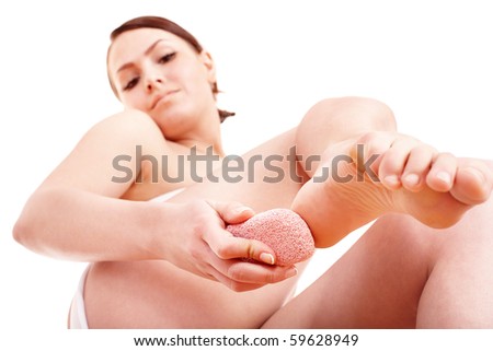 stock photo Woman rubbing heel of foot with pumice stone Isolated