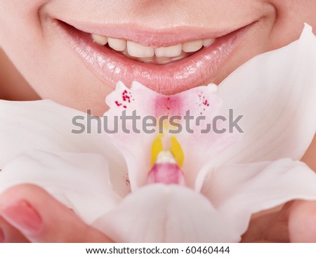 Female lips and orchid flower. Spa salon.