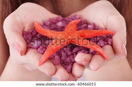 Closeup of hand with sea salt. Spa product.