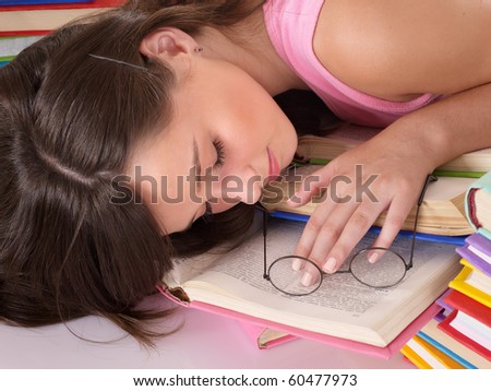 Girl sleep on pile of book. Education.