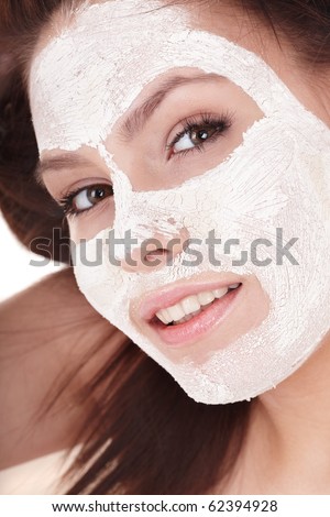 Young woman with clay facial mask.