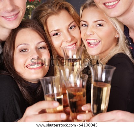 Group young people drink champagne at nightclub.