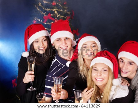 Group young people in santa hat drink champagne outdoor.